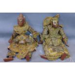 A pair of Southeast Asian (possibly Siamese) dolls, with painted wooden arms and heads, having