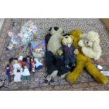 A group of toys including teddy bears and small dolls