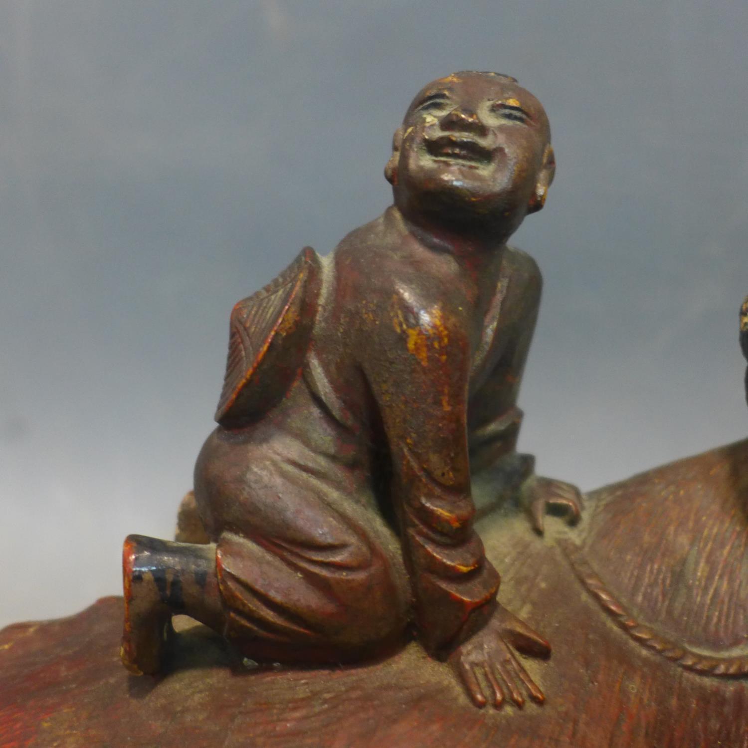 Two Chinese wooden sculptures of a child riding on water buffalo, second half 19th century - Image 3 of 4