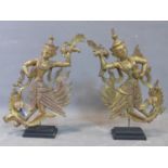 A pair of Southeast Asian gilt painted and mirrored glass inset wooden dancing figures, on stepped