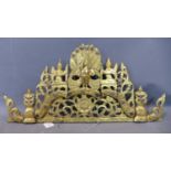 A Southeast Asian carved gilt painted and mirrored glass inset wooden pediment, with pierced