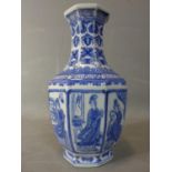 A late 20th century Chinese blue and white octagonal vase, decorated with panels of ladies in