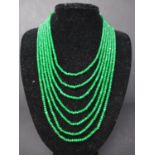 A 7 strand faceted beaded emerald necklace