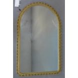 An arched giltwood mirror with pierced C-scroll frame, 84 x 53cm