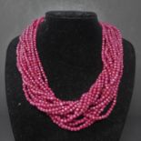 A 15 strand ruby necklace, with gold plated and cubic zirconia set leopard head clasp