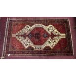 A North West Persian Koliahee rug, central diamond shaped medallion with repeating petal motifs on