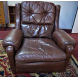 A 20th century brown leather armchair, H.88 W.94 D.71cm, together with a similar armchair, H.62 W.88