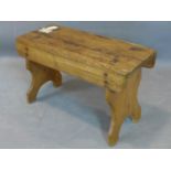 An early 20th century pine stool, on bracket feet, H.39 W.62 D.27cm