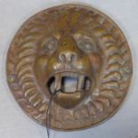 Antique bronze plaque in the for of a lion's head