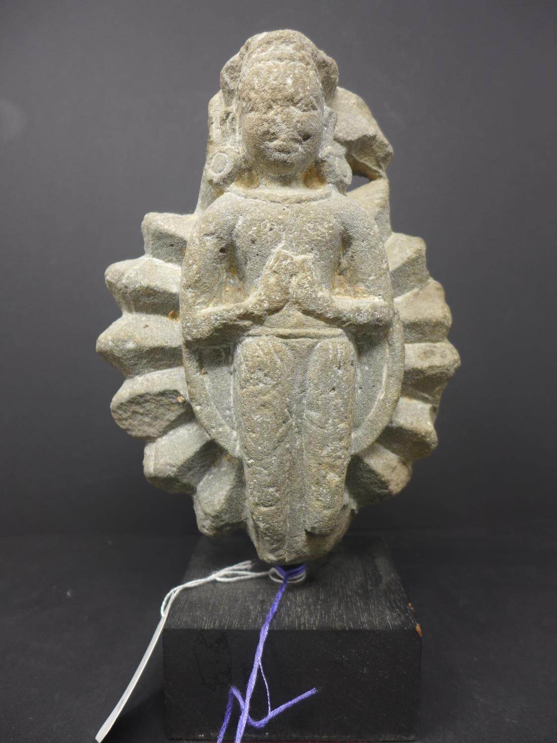 A stone carving of an indian goddess H.25cm