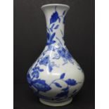 An early 20th century Chinese blue and white bottle vase, with floral decoration, H.22cm