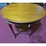 An Edwardian inlaid mahogany oval occasional table, with under tier, having boxwood lined frieze