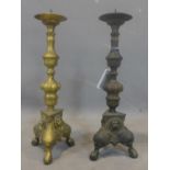 A pair of bronze pricket candlesticks, with knopped stems, on tri-form bases with lion mask and on