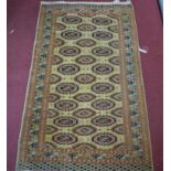 An antique Russian Turkoman Bokhara rug, elephant pad motifs on a cream ground, within geometric