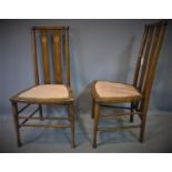A pair of late 19th century mahogany inlaid chairs, with inlaid back splats and stud bound seat,