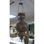 A Moroccan Mamounia copper ceiling pendant light, with pierced scroling decoration and coloured