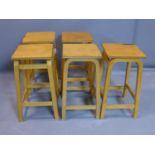 A set of five retro laminated beech stools, bearing labels, H.60cm