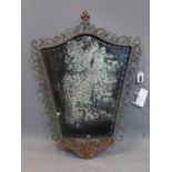 A mid 20th century mirror with pierced scrolling foliate frame and ghosted glass plate