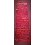 A contemporary woollen runner, in red, purple, pink and orange, 248 x 72cm