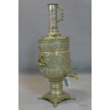 A Middle Eastern pewter Samovar, with twin handles, repousse decorated with scrolling foliage, on