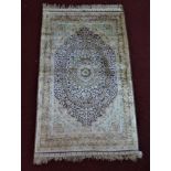 WITHDRAWN- A pure silk Persian Tabriz rug, signed, with central floral medallion on a purple