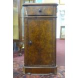 An early 20th century walnut and marble top telephone cupboard, with single drawer above a
