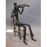 A cast bronze figure of a violinist in the style of Giacometti, H.27cm