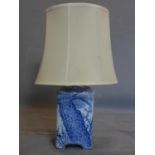 A Chinese blue and white table lamp, decorated with birds seated on a tree, with cream shade, H.33cm