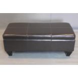 A contemporary faux leather ottoman, on tapering block feet, H.40 W.106 D.49cm