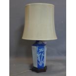A Chinese octagonal table lamp, with pierced panels and decorated with flowers, raised on