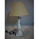 A distressed painted table lamp with cream shade, H.65cm (total)