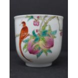 A Chinese famille rose teacup, decorated with a bird on a branch with fruit and flowers, H.7cm