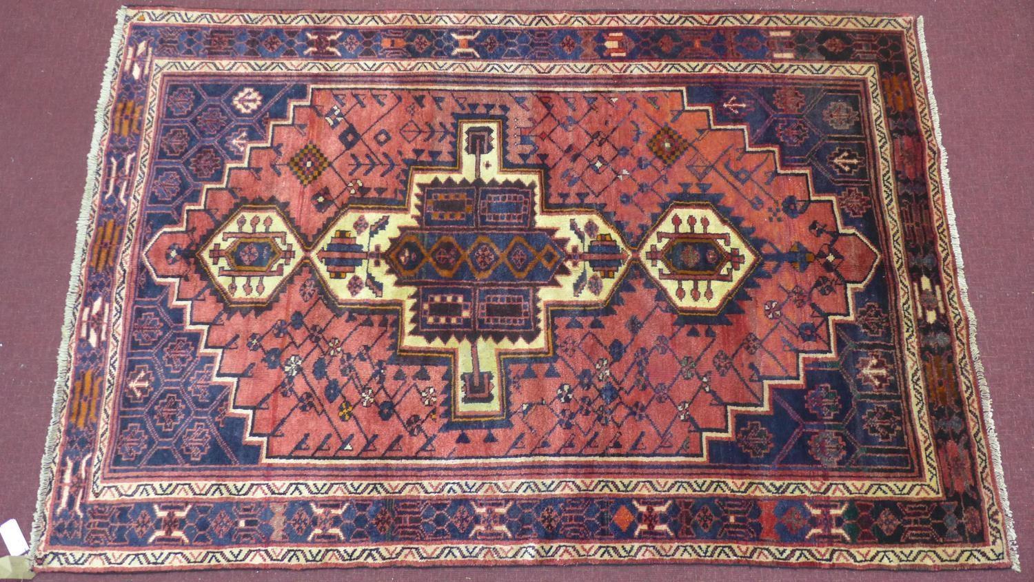 A north west Persian Afshar rug, 240cm x 160cm, triple polo medallion, with repeating geometrical