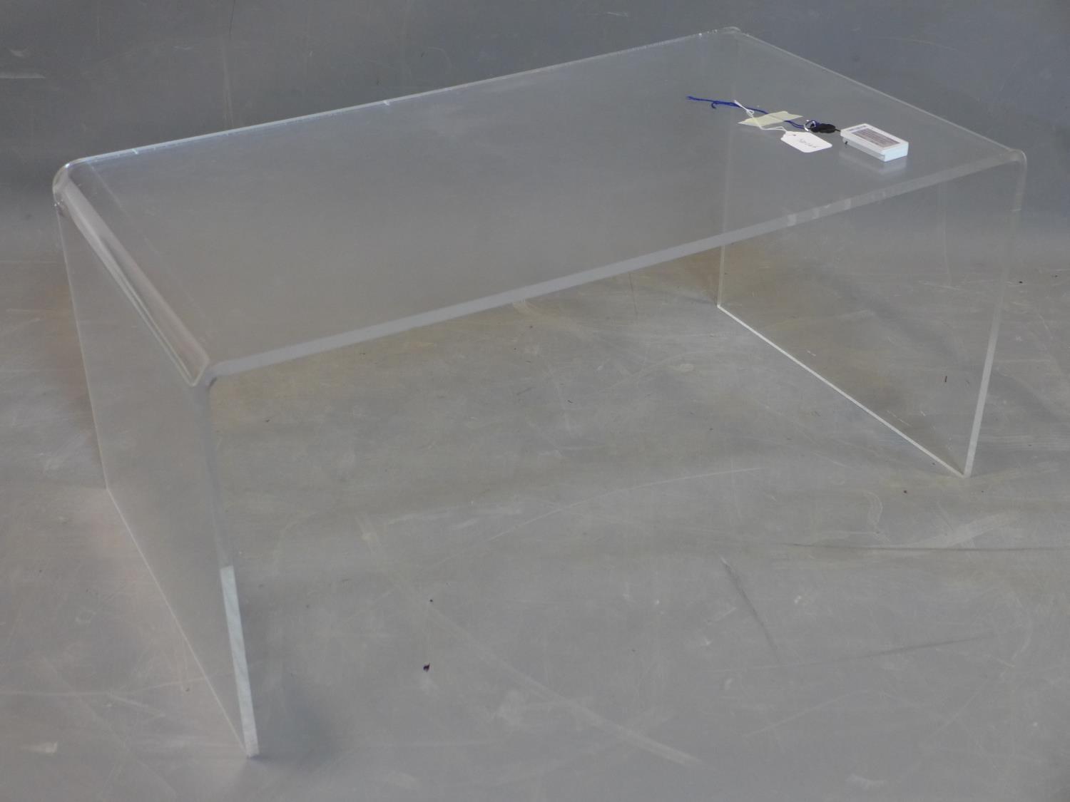 A perspex table, H.40 W.90 D.50cm