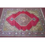 A north west persian Tabrize carpet 350cm x 250cm, central double diamand medallion on rouge