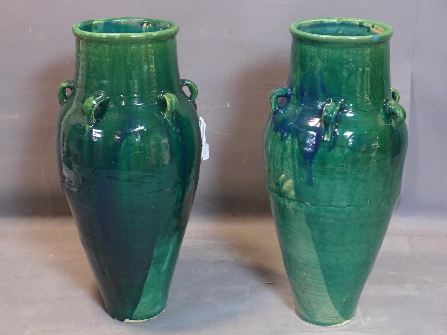 A pair of Persian green glazed Sharab wine vessels, H.94cm