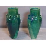 A pair of Persian green glazed Sharab wine vessels, H.94cm