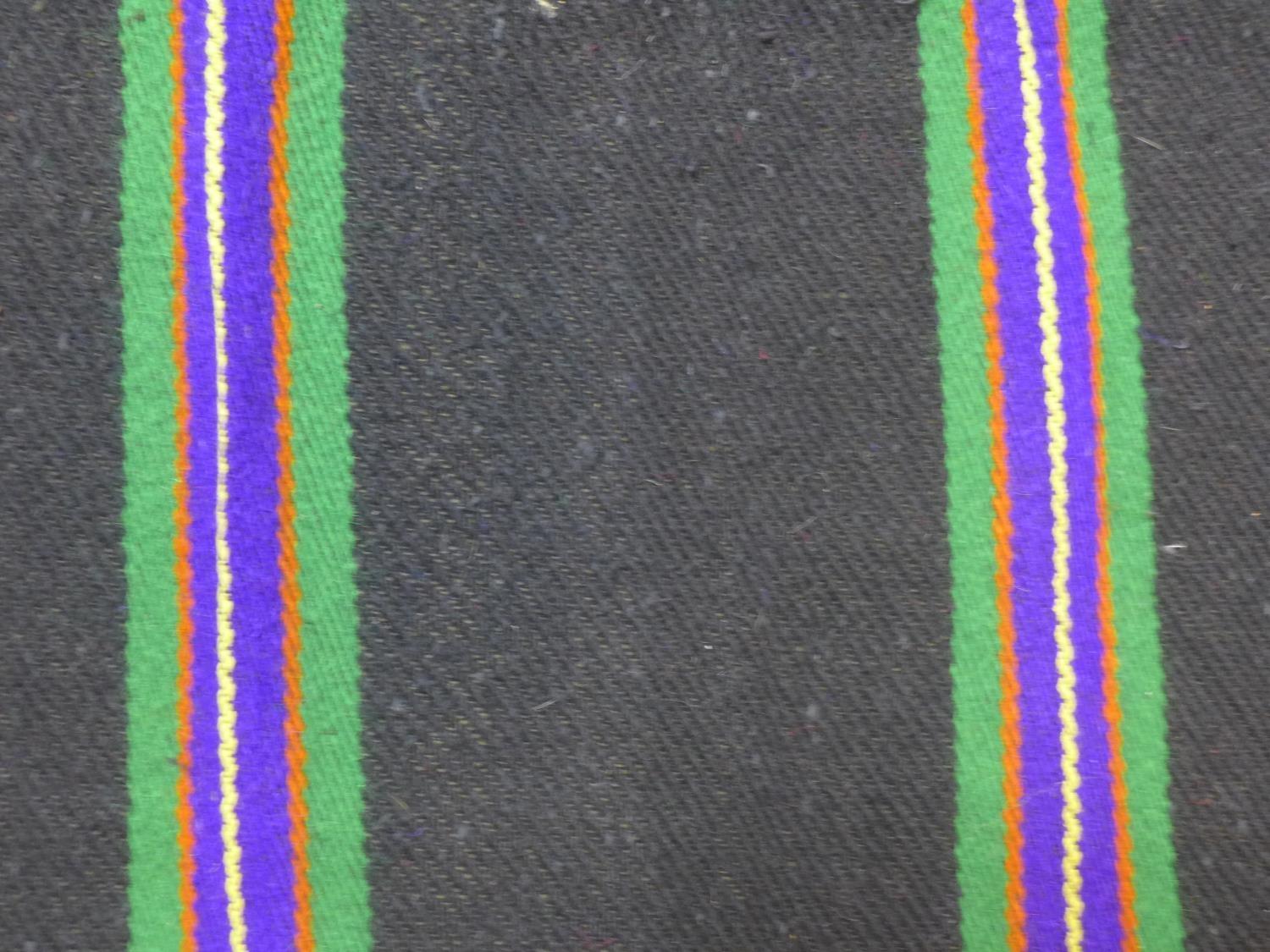 A woollen rug with purple, green, yellow and orange stripes on a black ground, 223 x 143 - Image 2 of 4