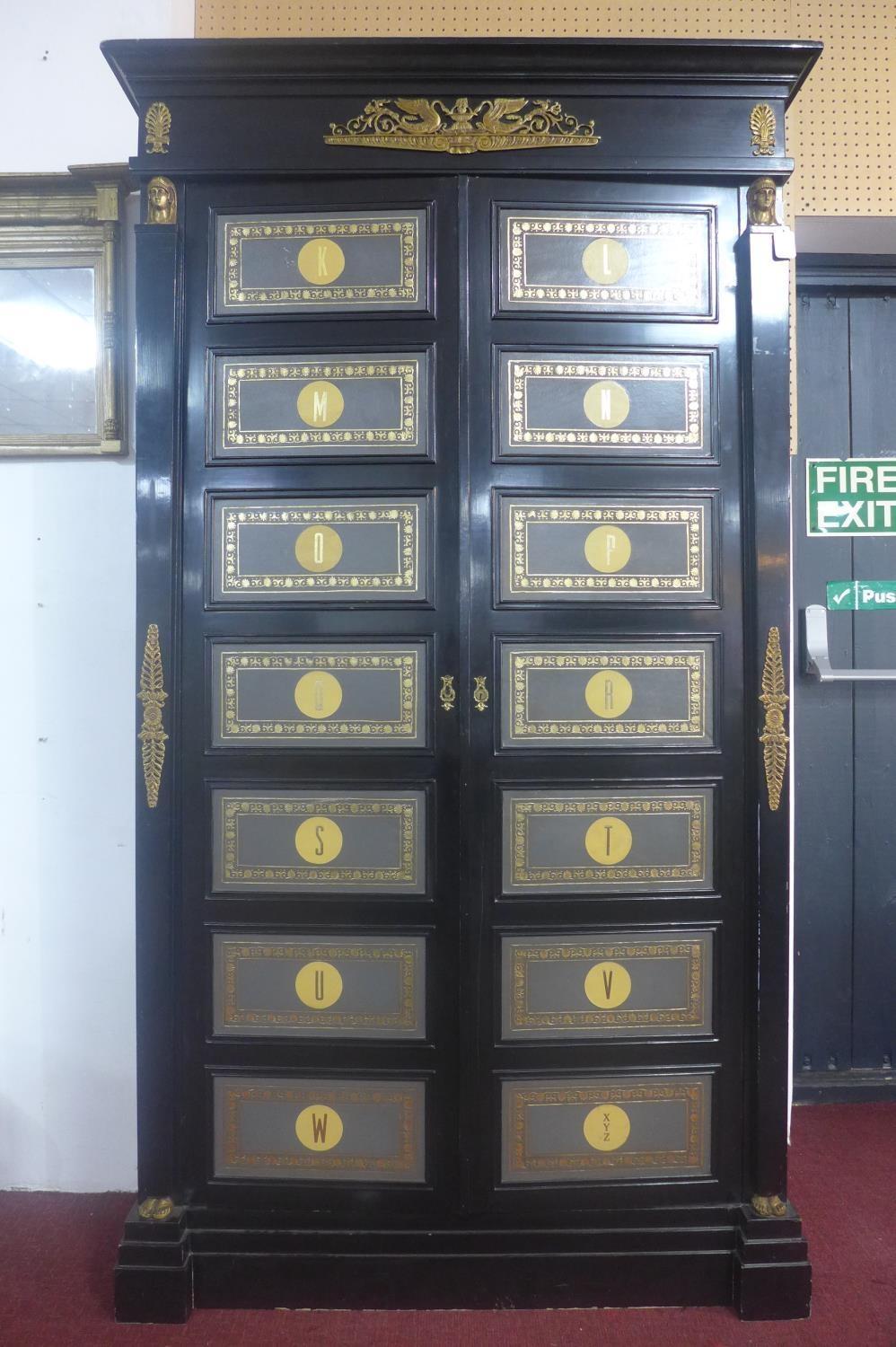 A neoclassical Empire style ebonised and ormolu mounted wardrobe