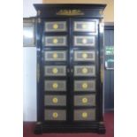A neoclassical Empire style ebonised and ormolu mounted wardrobe