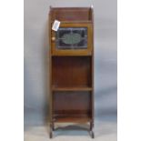 A small Arts and Crafts mahogany and inlaid narrow side cabinet, with single leaded glass door above