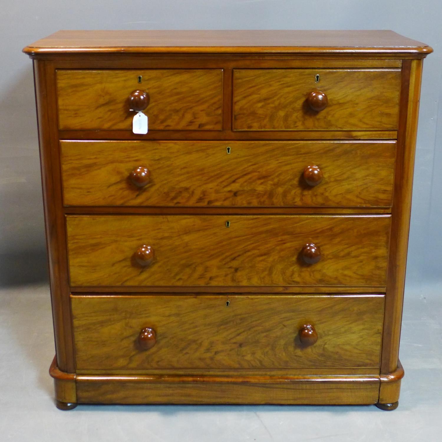 A Victorian walnut chest of two short over three long drawers, on pedestal base and bun feet, H.