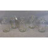 Five clear glass half gallon jugs