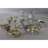 A collection of silver plated items including four schnapps glasses, two milk jugs, two sugar bowls,