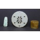 A Chinese celadon jade disk pendant, Diameter 6cm, together with a Chinese agate ring with panels of