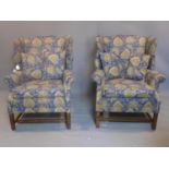 A pair of 20th century wingback armchairs, with Jane Churchill Limited designer fabric, on square