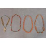 Three necklaces to include a coral beaded necklace, a turquoise and coral necklace, a turquoise,
