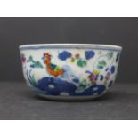 A Chinese doucai chicken tea cup, decorated with chickens and flowers, with double blue circle to