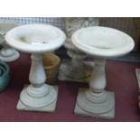 Two reconstituted stone Classical style bird baths, on baluster supports and stepped circular bases,