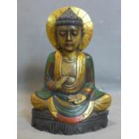 An Indonesian carved and polychrome painted wooden seated Buddha, H.55cm